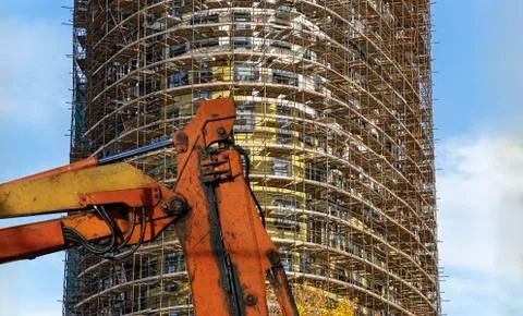 Part of a construction machine  with multi-storey building under construction Stock Photos