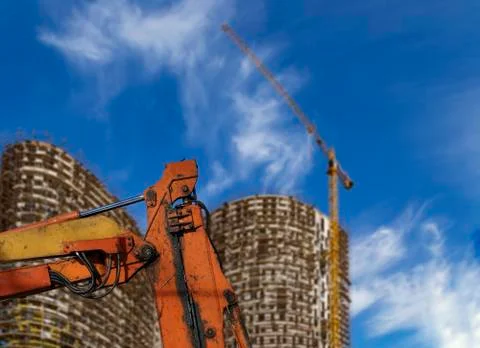 Part of a construction machine  with multi-storey building under construction Stock Photos