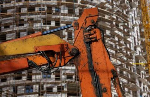 Part of a construction machine  with multi-storey building under construction Stock Photos