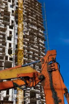 Part of a construction machine  with multi-storey building under construction Stock Photos