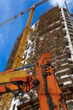 Part of a construction machine  with multi-storey building under construction Stock Photos