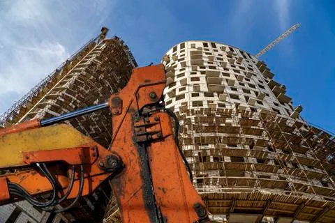 Part of a construction machine  with multi-storey building under construction Stock Photos