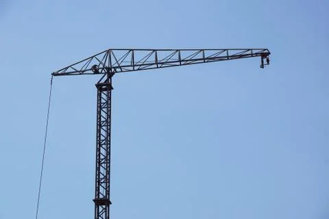 Part of a construction tower crane against the blue sky Stock Photos