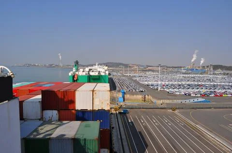 Part of container ship with RORO ship on in port at the car terminal on loadi Stock Photos
