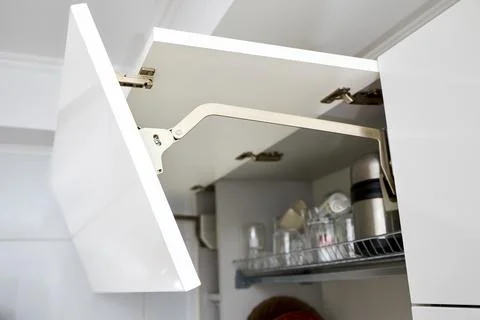 Part of contemporary kitchen interior. Opened White horizontal Kitchen Cabinet Stock Photos