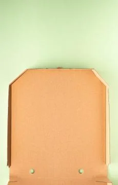 Part of empty pizza box on green paper background Stock Photos