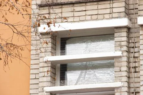 Part of the facade of the building with plastic spikes against pigeons. the Stock Photos