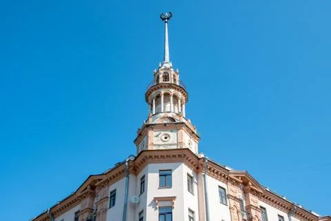 Part of the facade of the old building with a spire and a star against the sky Foto stock