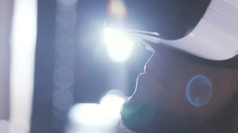 Part of face of young man in virtual reality goggles looking straight and Stock Footage 98190723