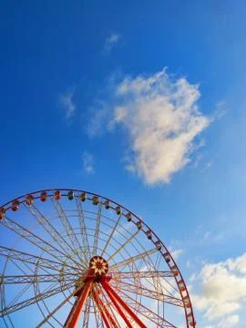 Part of ferris wheel with  soft clouds at sunset Stock Photos
