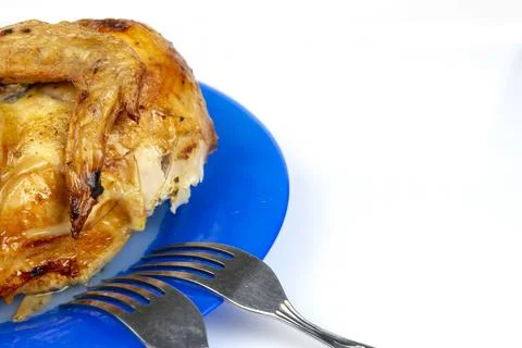 Part of fried chicken on a ceramic dish close-up Stock Photos