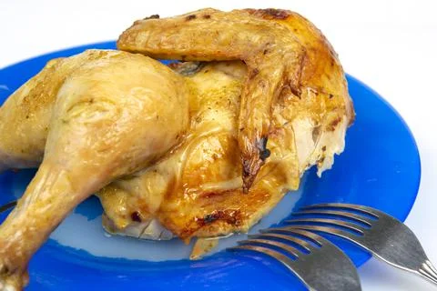 Part of fried chicken on a ceramic dish close-up Stock Photos