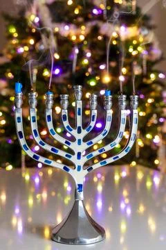 As part of Hanukkah traditions, menorah is lit with nine candles. Stock Photos