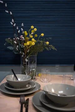 Part of home kitchen table setting with gray plates. Stock Photos