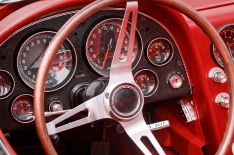 Part of interior with steering wheel, speedometer, revs, fuel, oil, water tem Stock Photos