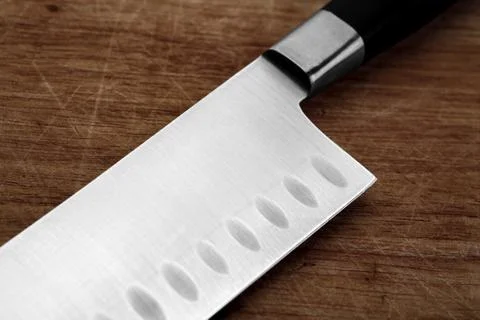Part of the kitchen knife on an old cutting board Stock Photos