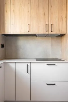 Part of kitchen with a table along wall. Table with gray marble top and black Stock Photos