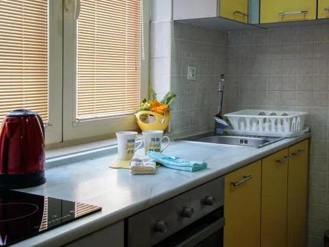 Part of the kitchen where cups and towels are placed Photos