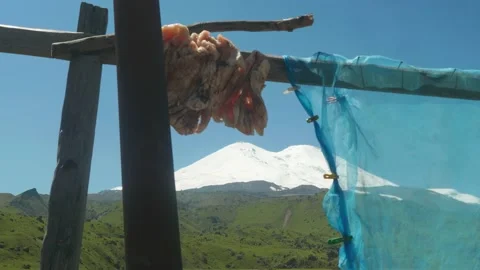 Part of lamb fat tail hagining on wooden sticks. Elbrus region. Stock Footage 140800689