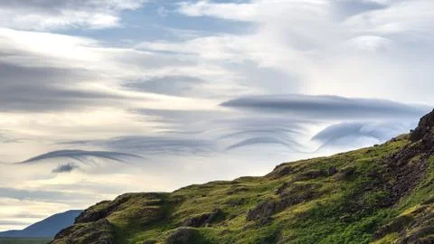 Part of the The Langdales gives the backdrop to cloud formations during sunse Stock Photos