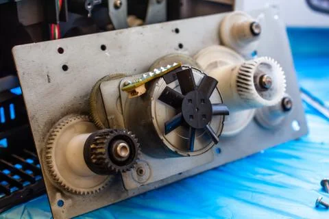 Part of laser printer - block with a electric motor and cogwheels. Stock Photos