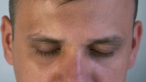 Part of man's face with closed eyes and eyebrows before lash lamination. Video stock 159539647