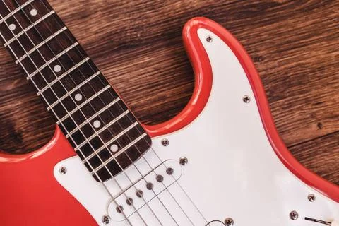 Part of modern electric six string guitar red color with glossy finish, picku Stock Photos