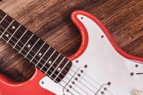 Part of modern electric six string guitar red color with glossy finish, picku Foto stock