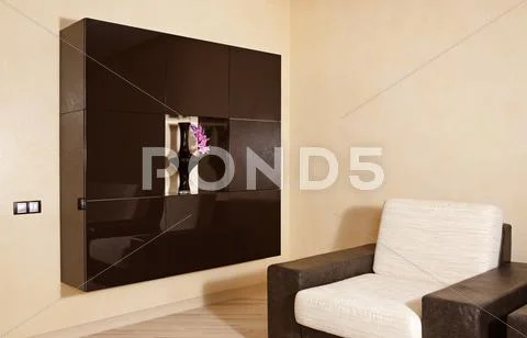 Part of modern interior in warm tones with armchair and niche Stock Photos