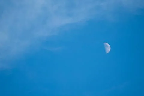 Part of the moon on blue background. Stock Photos