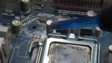 The part of the motherboard with the processor is cleaned from dust using a pear Stock Footage 131095143
