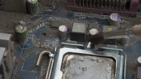 Part of the motherboard with the processor is cleaned from dust with a brush Stock Footage 131095210