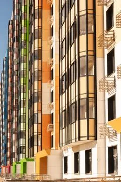 Part of the multi-colored facade of a multi-storey residential building. Stock Photos