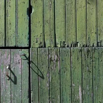 Part of old green painted barn door with vertical planks Stock Photos