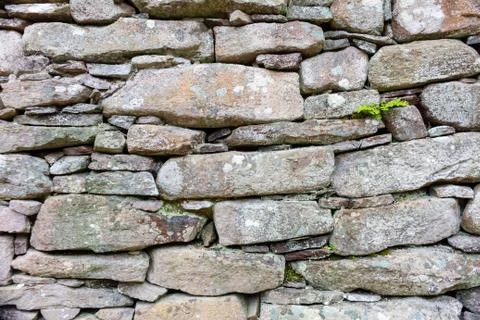 Part of a old stone wall, for background or texture. Stock Photos