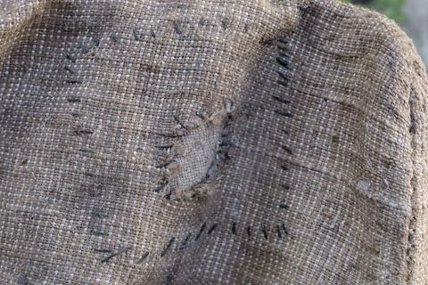 Part of old torn sack of coarse sackcloth with patch Stock Photos
