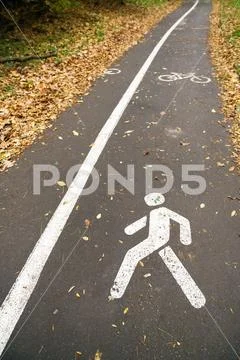 Part pedestrian and cycle track with painted symbols pedestrian rights ...