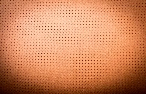 Part of perforated red  leather texture Stock Photos