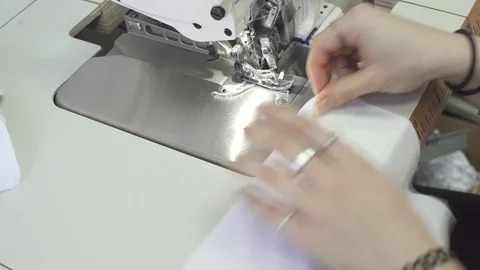 As part of the practice, the teenager throws quacks of fabrics on overlock, whic Video stock 128448792