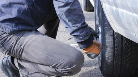 Part of the process of changing wheels on a car Stock Photos