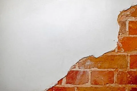 Part of the red brick wall of an old house with a figured pattern of white pu Stock Photos