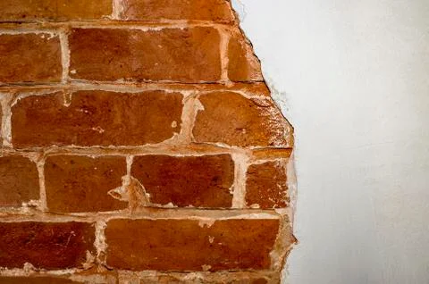 Part of the red brick wall of an old house with a figured pattern of white pu Stock Photos