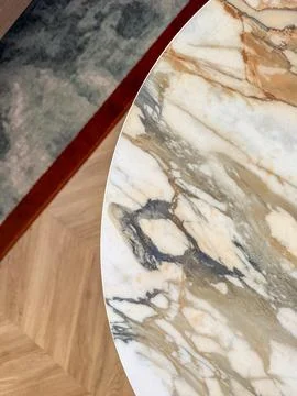 Part of round marble table with grey carpet on background Stock Photos