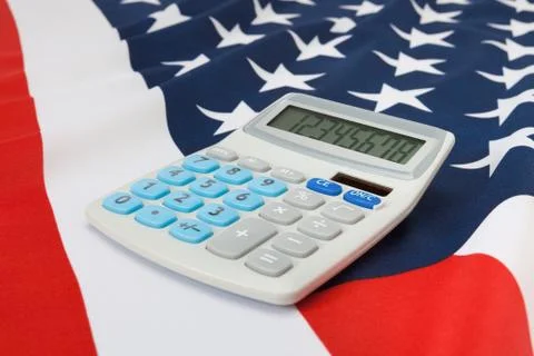 Part of studio close up shoot ruffled national flag with calculator on it ser Stock Photos