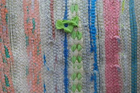 Part of the texture of a multi-colored vintage rug with a simple weave. Stock Photos