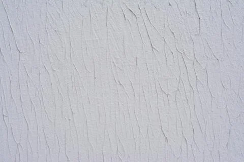 Part of the texture of a white wall decorated with decorative putty Stock Photos