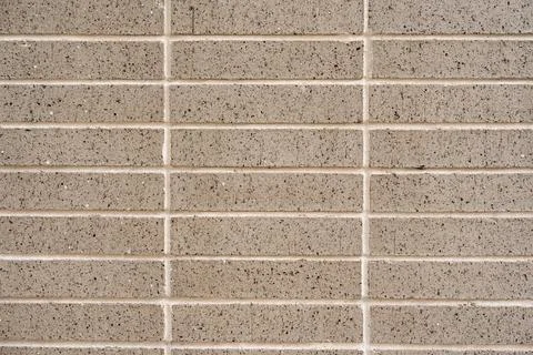 Part of wall covered with rectangular ceramic tiles arranged in a horizontal 스톡 사진