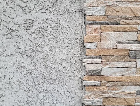 Part of the wall finished with decorative plaster and part with shaped bricks Stock Photos