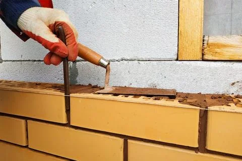 Part of the wall of red facade brick, clearly visible lines. 스톡 사진
