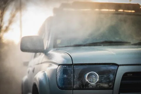 Part of a white car in a cloud of splashing clean water at a self-service car Stock Photos